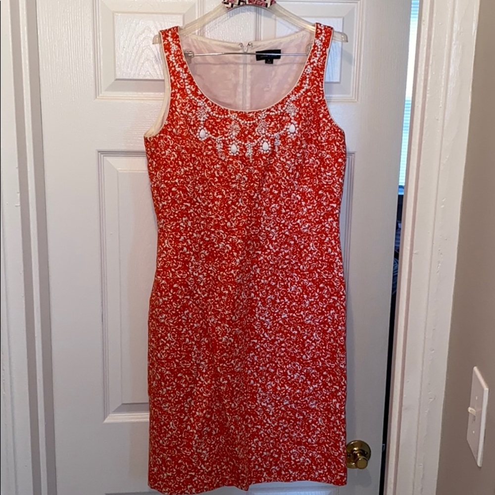 Women’s red and white dress with beaded neckline
